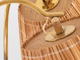 a close up of a lamp with a rattan shade on it