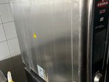 a silver microwave sitting on top of a counter in a kitchen