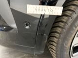 a measuring tape on the front bumper of a car