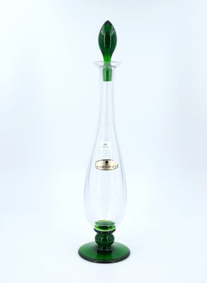 a green glass vase with a green stem sitting on top of a green base