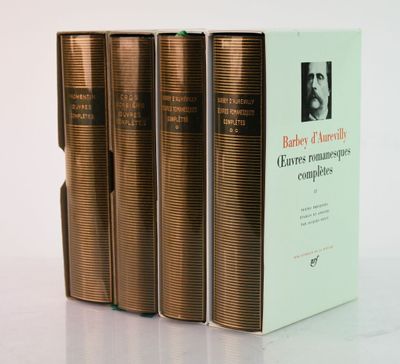 three books sitting on top of a white table next to each other