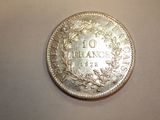 an image of a silver coin with the number 10 on it