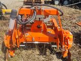 a close up of a tractor with a plow attached to it