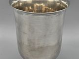 a silver cup on a pedestal on a white background