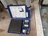 une boîte bleue contenant une balance et un téléphone portable