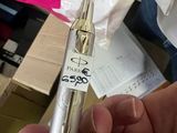 a person holding a silver pen in their hand