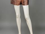 a mannequin mannequin wearing a white top and brown shorts