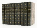 the books are lined up in a row on a white surface