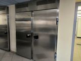 a row of stainless steel refrigerators in a commercial kitchen