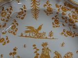 a plate that has a gold and white pattern on it