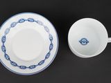 a close up of a cup and saucer on a table