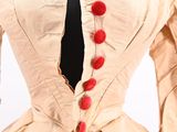 an image of a dress with red buttons on the back