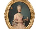 portrait of a young girl in a pink dress holding a bird
