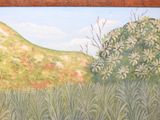 a painting on the wall of a field with a mountain in the background