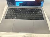 a laptop computer sitting on top of a white box