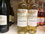 several bottles of wine are lined up on a counter