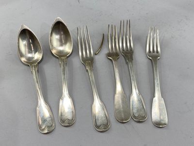 six forks and spoons are lined up on a table