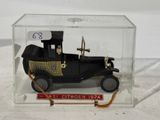 a small toy car in a clear box on a table