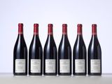 six bottles of red wine lined up in a row