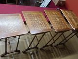 three folding tables with chess boards on them in a room