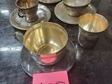 many cups and saucers sitting on a table