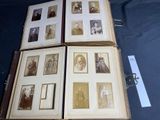 a lot of old photos in a book on the table