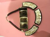 a picture of a necklace that is hanging on a wall