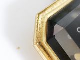 a close up of a clock on a white surface