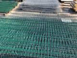 a close up of a pile of green gabio nets on the ground