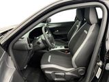 the interior of a car with the door open showing the driver ' s seat area