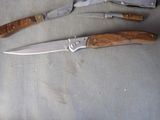 two knives and a knife holder on a table
