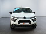 the front of a white car is parked in a white room