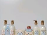 bottles of soap and lotion sitting on a table next to a box of soap