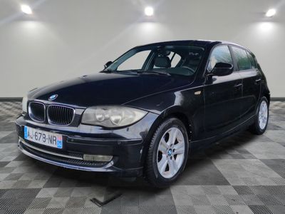 a picture of a black bmw car parked in a garage