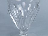 a clear glass bowl on a table with a light blue background