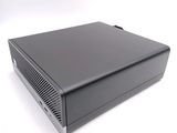 the back view of a small black computer on a white surface
