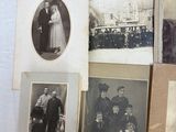 many old photos of people on the wall