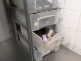 a shelf with three drawers on it in a bathroom