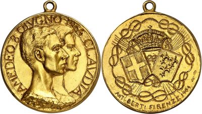 a close up of two gold medals on a white background