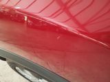 a close up of a red car ' s paint job