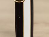 a black and white striped lighter sitting on top of a wooden table