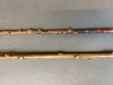two wooden sticks with holes in them sitting on a table