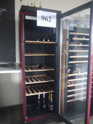 a wine cooler with a lot of bottles inside of it