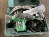 a green box with tools in it on the floor