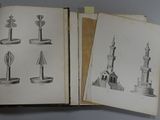an open book with drawings of a lighthouse and a clock tower