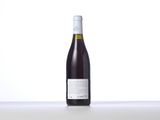 a bottle of red wine sitting on top of a table