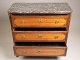 an antique chest of drawers with marble top