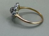 a gold and silver ring with a flower on it