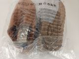 two pieces of bread wrapped in plastic on a table
