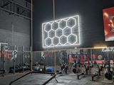 a gym with a lot of equipment in the middle of it